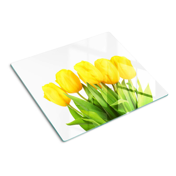 Edzett üveg vágódeszka Sárga tulipánok zöld háttér előtt