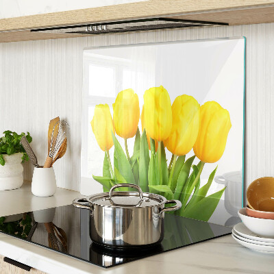 Edzett üveg vágódeszka Sárga tulipánok zöld háttér előtt