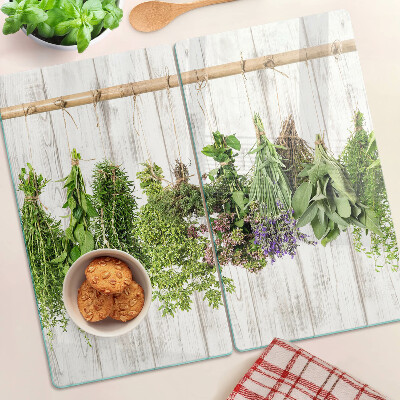 Üveg vágódeszka Gyógynövények fa háttéren