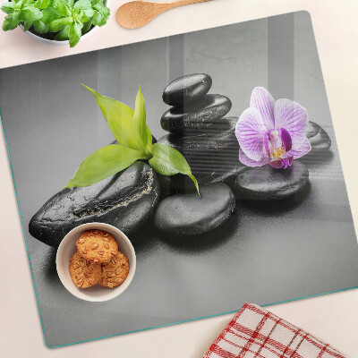 Edzett üveg vágódeszka Kövek és orchidea a háttérben