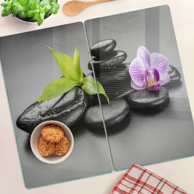 Edzett üveg vágódeszka Kövek és orchidea a háttérben