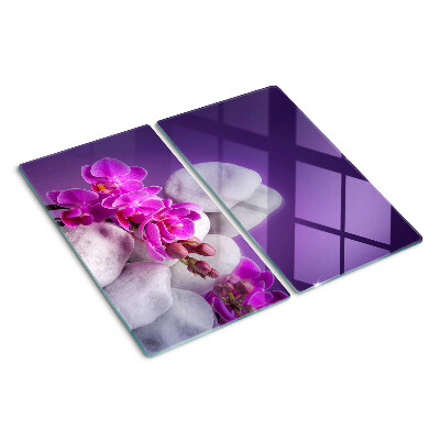 Üveg vágódeszka Orchidea virágok kövek hátterében