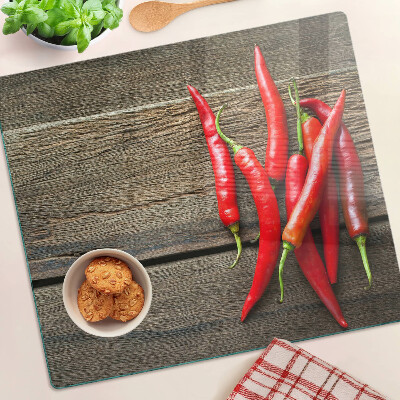 Üveg vágódeszka Chili paprika fa háttéren